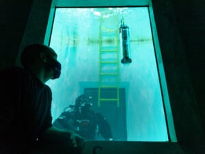 Watching how the microFloat responds to small weights added by the APL diver in UW Oceanography's saltwater tank. Photo credit: Mark Stone