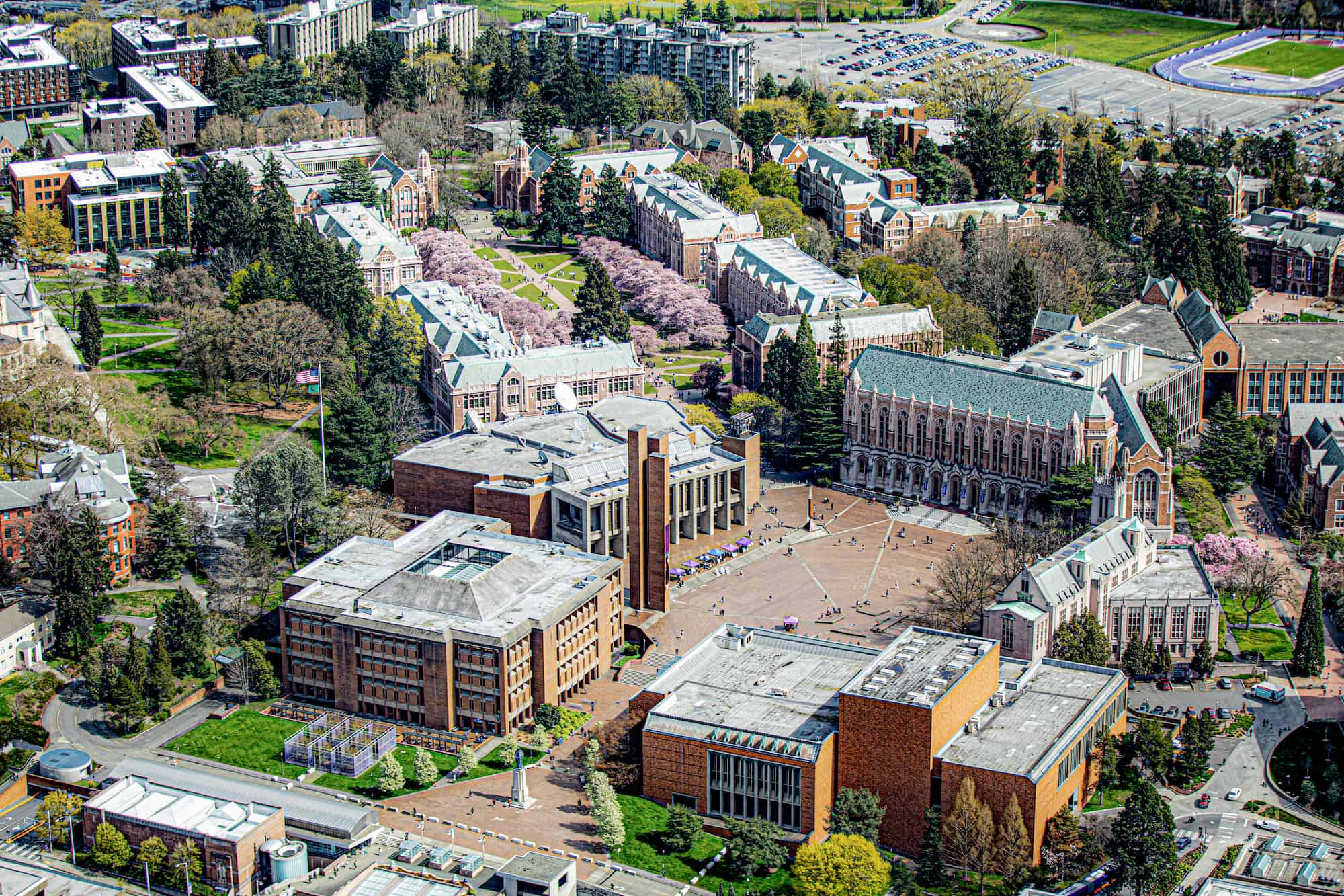 Aerial view of University of Washington campus, Red Square is at center, with The Quad at the top, cherry trees in bloom